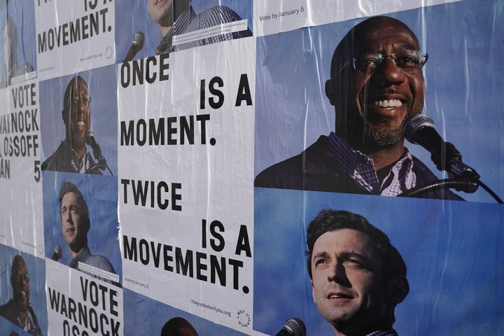 Campaign ads for Jon Ossoff and Raphael Warnock are seen on a wall near the John Lewis mural the day after the U.S. Senate runoff elections in Atlanta.