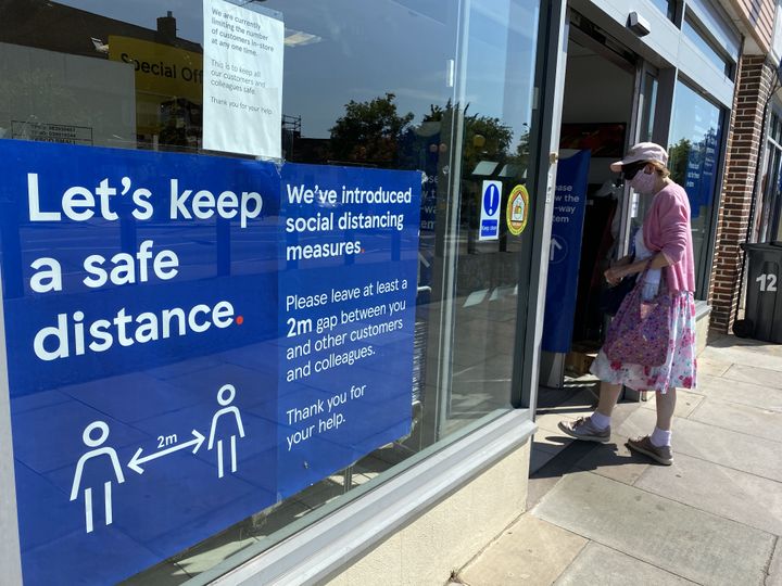 The sign of "Let's keep a safe distance" on the window of Tesco express store, London
