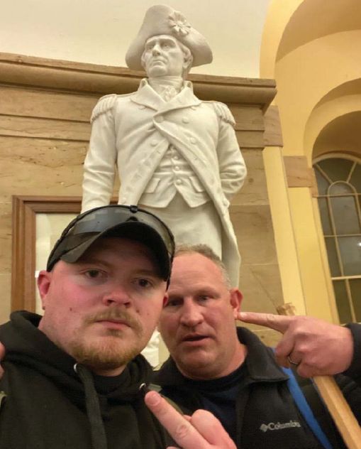Police officers Jacob Fracker and Thomas Robertson took a selfie inside the U.S. Capitol during an insurrection.