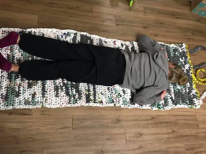 Kathy Kibble's daughter lies on a sample mat, to give a frame of reference for size.