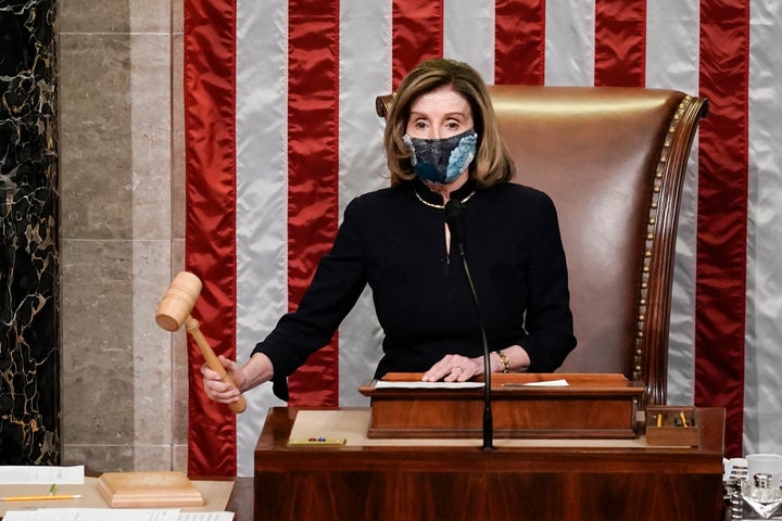 Speaker of the House Nancy Pelosi (D-Calif.) gavels in the final vote of the historic second impeachment of President Donald Trump on Wednesday. 