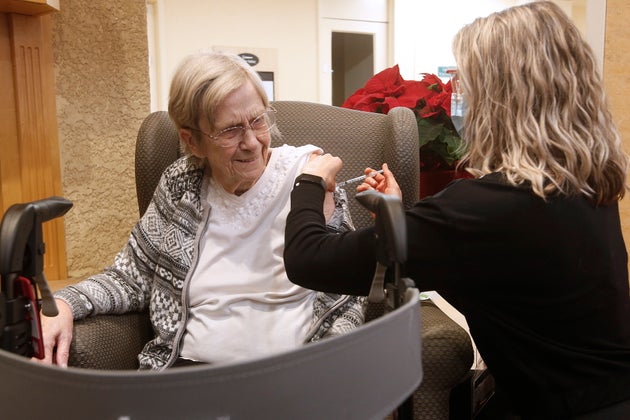 Paramedic Jessi Bittner inoculates Margaret Watson, 94, a resident at Oakview Place Long Term Care Residence, with her COVID-19 vaccine in the Winnipeg care home on Monday.