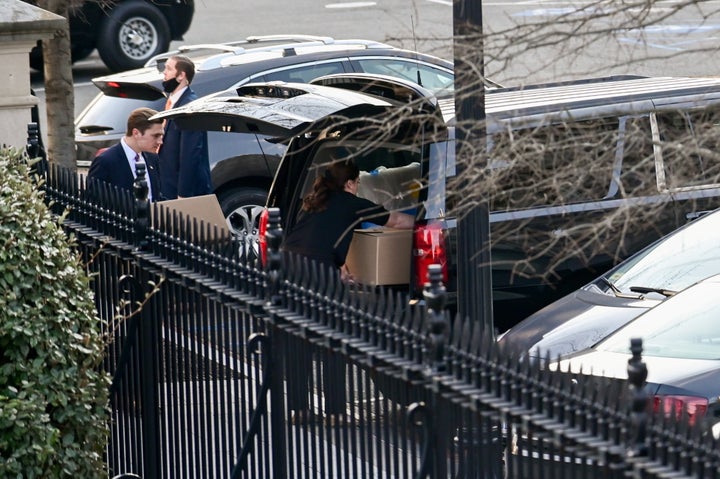 People load boxes and other items from the West Wing of the White House into a vehicle on Wednesday.