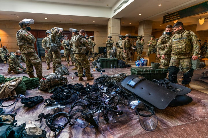 Members of the National Guard gather inside the Capitol Visitor Center, Wednesday, Jan. 13, 2021, in Washington as the House of Representatives continues with its fast-moving House vote to impeach President Donald Trump, a week after a mob of Trump supporters stormed the U.S. Capitol. (AP Photo/Manuel Balce Ceneta)