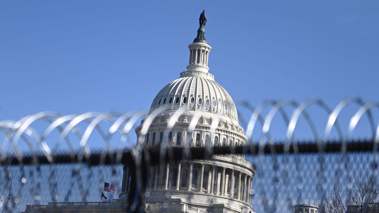 Barbed wire is installed on the top of a security fence surrounding the U.S. Capitol in Washington on Thursday ahead of next week's presidential inauguration of Joe Biden.