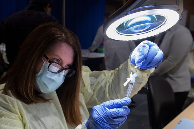 A dose of the Pfizer-BioNTech COVID-19 vaccine is prepared by Pharmacy Technician Supervisor Tamara Booth...