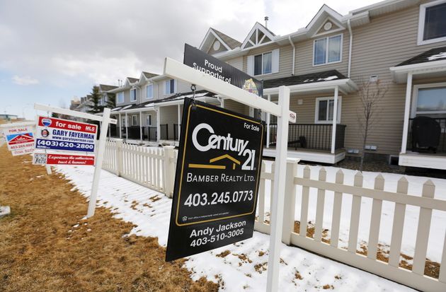 For sale signs are spotted in Calgary in April 2015. CREA says some 551,392 homes were sold in 2020 in