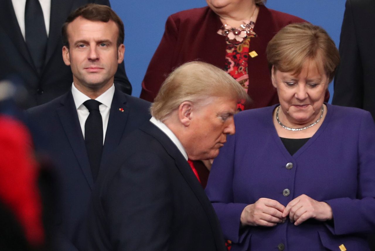 President Donald Trump in front of French President Emmanuel Macron (left) and German Chancellor Angela Merkel (right).