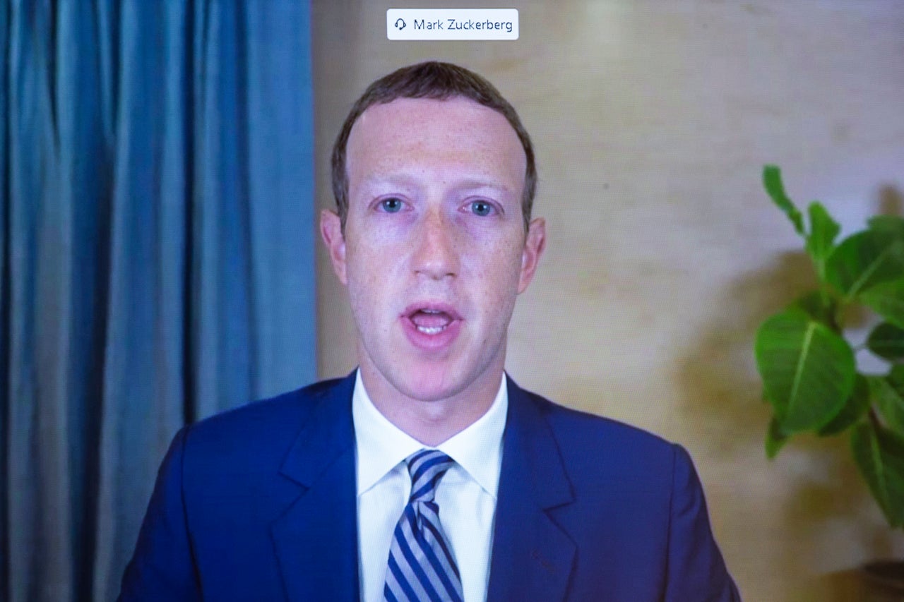 Facebook CEO Mark Zuckerberg appears on a screen as he speaks remotely during a hearing before the Senate Commerce Committee on Oct. 28.