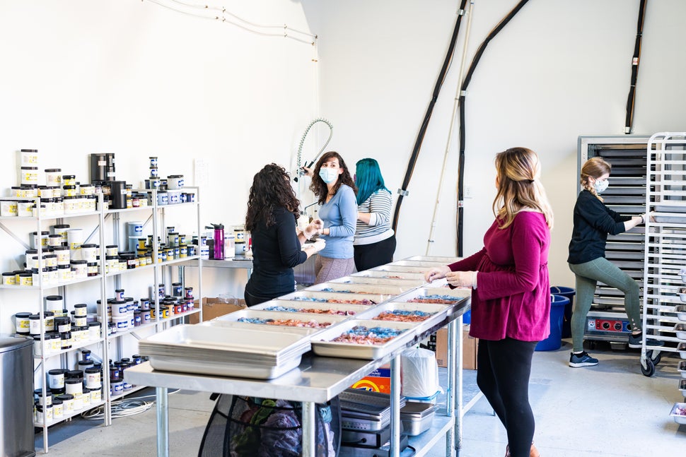 Sewrella employees work to dye yarn colorways in their new commercial space.