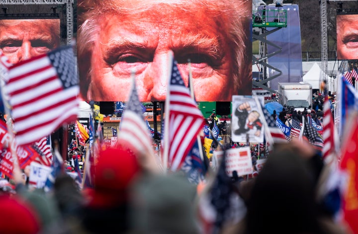 An image of President Donald Trump appears on video screens before his speech to his supporters on Jan. 6, 2021.