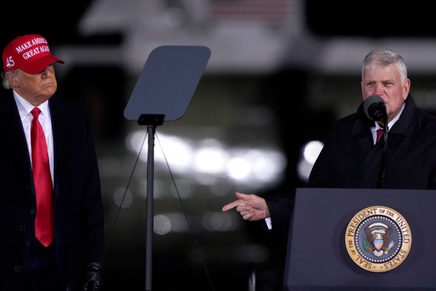 President Donald Trump listens as Franklin Graham prays at a Nov. 1 campaign rally in Hickory, North