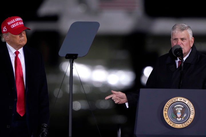 President Donald Trump listens as Franklin Graham prays at a Nov. 1 campaign rally in Hickory, North Carolina.