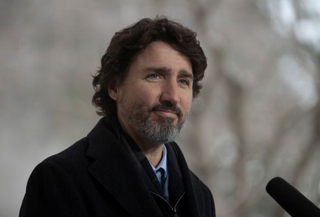 Prime Minister Justin Trudeau listens to a question from a reporter during a news conference outside...