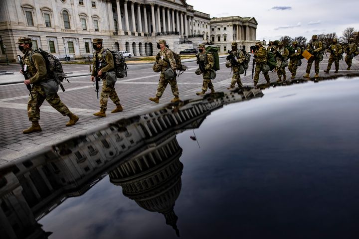Virginia National Guard troops march across the east front of the U.S. Capitol on their way to their guard posts on Jan. 16 in Washington, DC. After the Jan. 6 riots at the U.S. Capitol, the FBI has warned of additional threats in the nation's capital and in all 50 states.