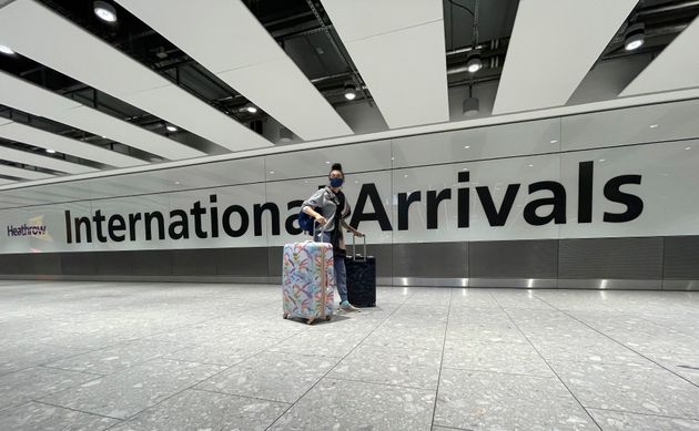 Travellers arrive at Heathrow Airport in London, Sunday, January 17.