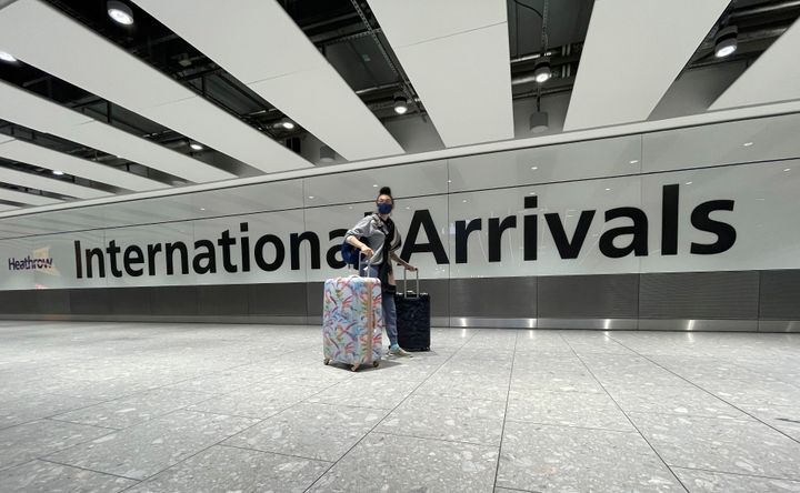 Travellers arrive at Heathrow Airport in London, Sunday, January 17.