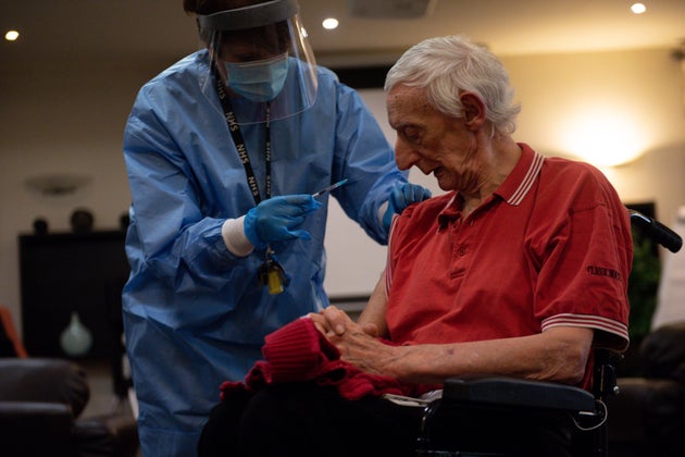 Care home resident David Price receives an injection of the coronavirus vaccine at Andrew Cohen House in Birmingham.