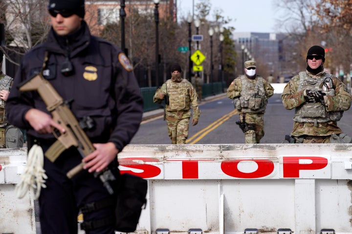 A barrier is guarded on Saturday, Jan. 16, 2021, in Washington as security is increased ahead of the inauguration of Presiden