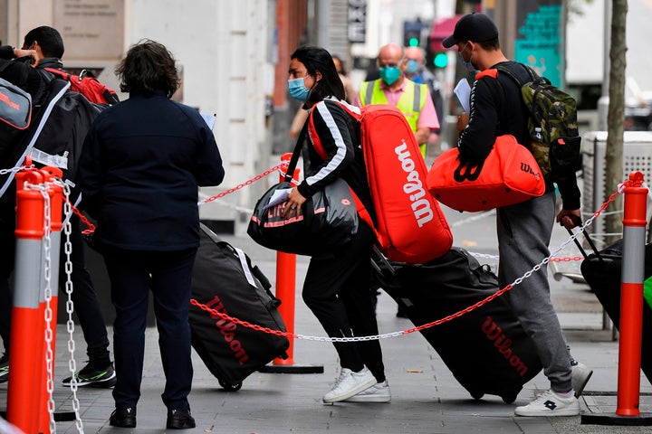 Tennis players, coaches and officials arrive at a hotel in Melbourne on January 15, 2021, before quarantining for two weeks ahead of the Australian Open tennis tournament. 