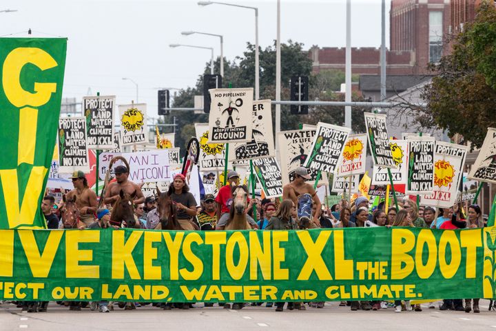 In this Aug. 6, 2017, file photo, demonstrators against the Keystone XL pipeline march in Lincoln, Neb. 