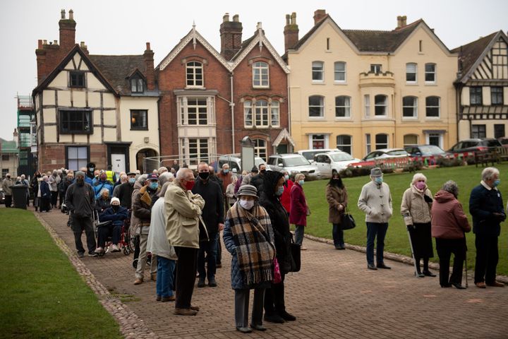 Members of the public queue outside Lichfield Cathedral, Staffordshire, to receive an injection of the Oxford/AstraZeneca coronavirus vaccine.