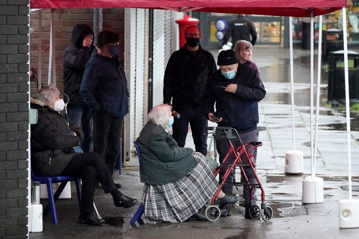 People queue to be administered the Covid-19 vaccine in Macclesfield.