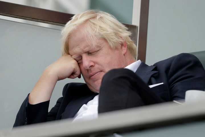 Boris Johnson sits with his eyes closed as he attends the fifth cricket test match of a five match series between England and India at the Oval cricket ground in 2018