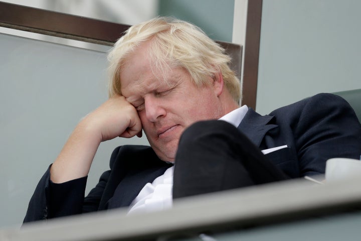 Boris Johnson sits with his eyes closed as he attends the fifth cricket test match of a five match series between England and India at the Oval cricket ground in 2018