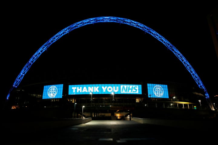 Wembley stadium is seen lit up blue for the Clap For Our Carers campaign in support of the NHS during the coronavirus pandemic in March