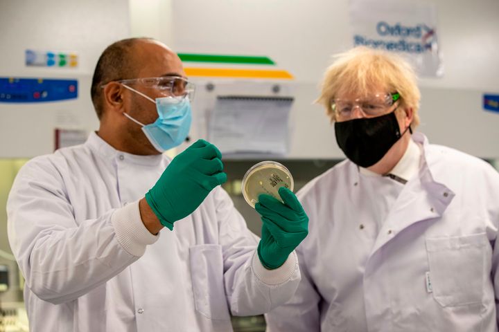 Boris Johnson speaks with Dipesh Sonar as he visits the quality control laboratory at Oxford BioMedica where batches of the Oxford/AstraZeneca Covid-19 vaccine are tested as part of the manufacturing process