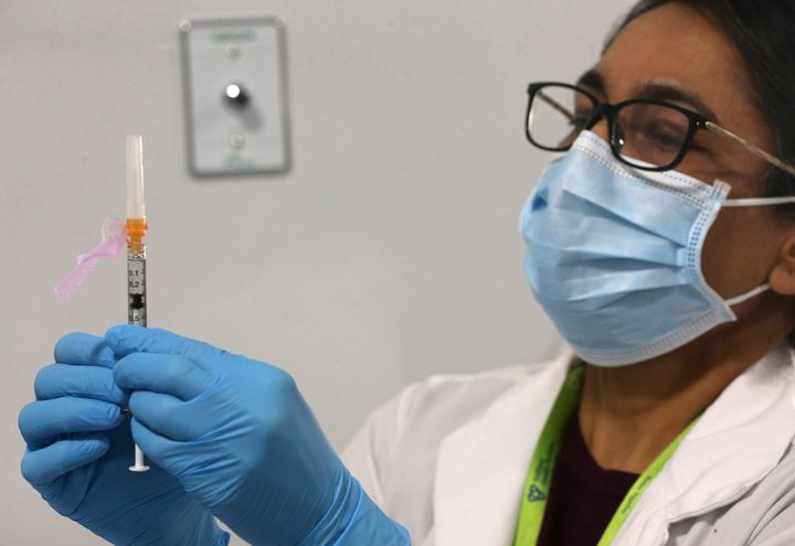 Nurse Nasha Zaheer prepares a dose of the Pfizer vaccine for COVID-19 at Camilla Care Community in Mississauga, Ont. on Dec. 21, 2020.
