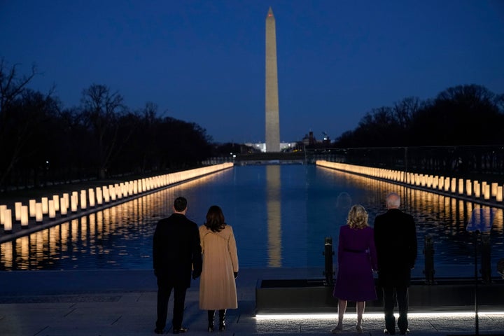 President-elect Joe Biden and his wife Jill Biden, along with Vice President-elect Kamala Harris and her husband, Doug Emhoff, look at lights placed around the Lincoln Memorial Reflecting Pool on Jan. 19, 2021, in Washington. 