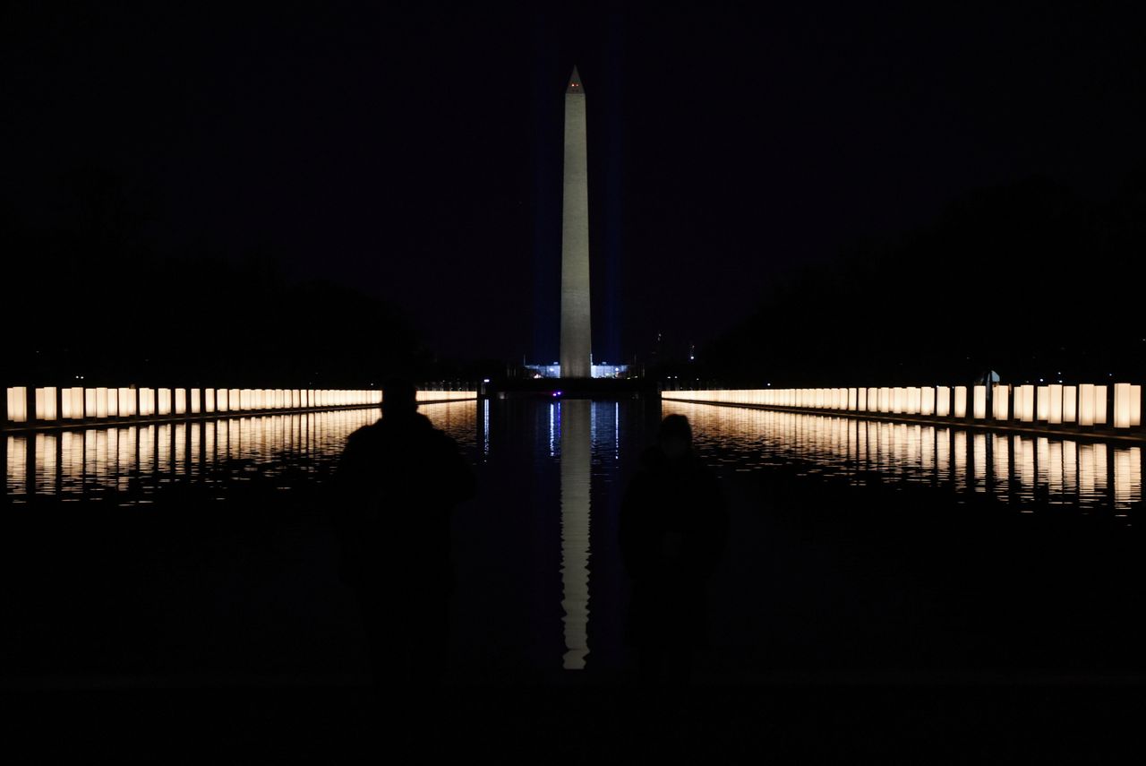 Lights illuminated the Reflecting Pool after President-elect Joe Biden hosted a memorial to honor those who have died in the U.S. from the coronavirus.