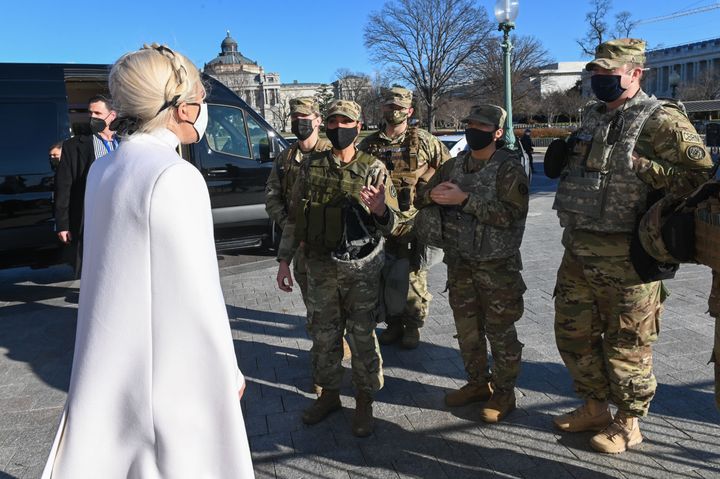 Lady Gaga, left, greets National Guard soldiers after rehearsing on Tuesday for the inauguration of President-elect Joe Biden in Washington, DC