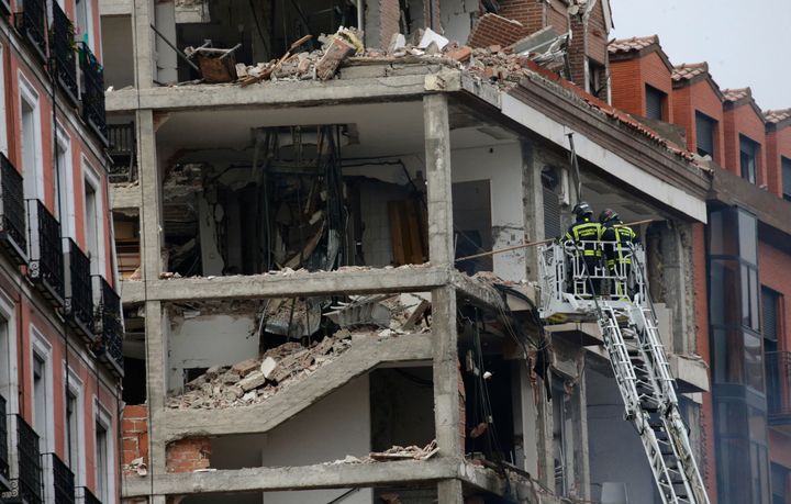 Firefighters work on a damaged building at Toledo Street following an explosion in downtown Madrid, Spain, on Wednesday