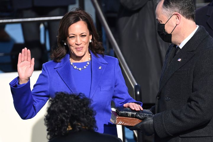 Kamala Harris — flanked by her husband, Doug Emhoff, who is holding two Bibles — is sworn in as vice president by Justice Sonia Sotomayor.