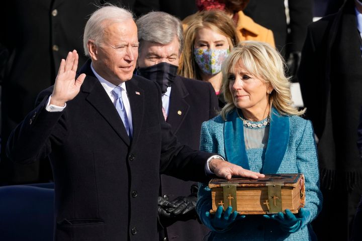 Joe Biden is sworn in as the 46th president of the United States as Jill Biden holds the Bible at the U.S. Capitol on Jan. 20, 2021.