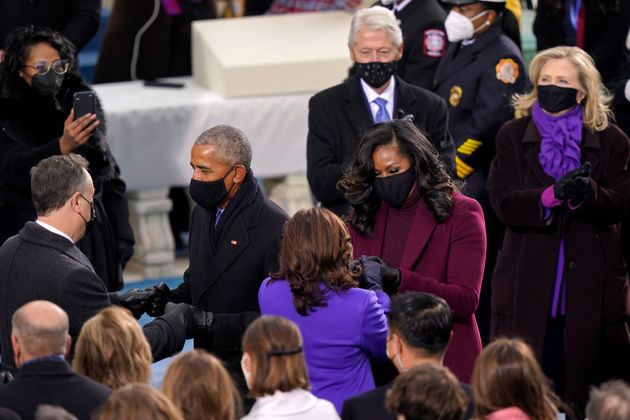 Note the pops of colour as Michelle Obama greets Kamala Harris, with Hillary Clinton looking on.