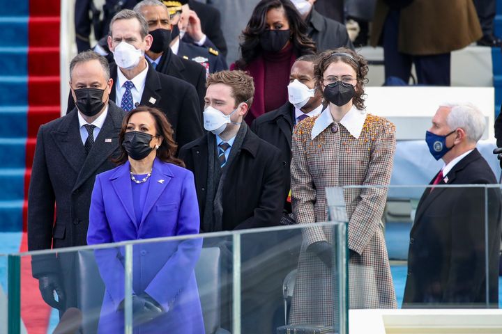 Doug Emhoff, Vice President Kamala Harris, Cole Emhoff, Ella Emhoff, and former Vice President Mike Pence stand as Lady Gaga arrives to sing the National Anthem at the inauguration on Jan. 20.