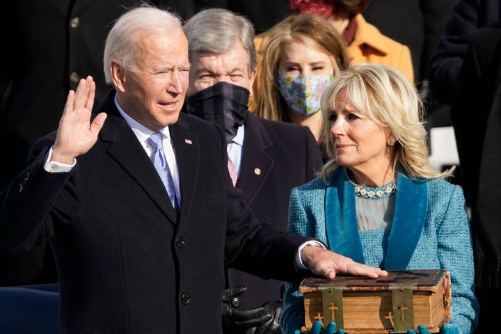 Joe Biden is sworn in as the 46th president of the United States by Chief Justice John Roberts as Jill Biden holds the Bible.