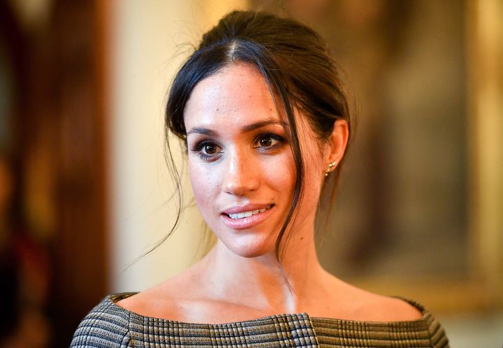 Meghan Markle chats with people inside the Drawing Room during a visit to Cardiff Castle on Jan. 18, 2018, in Cardiff, Wales. 