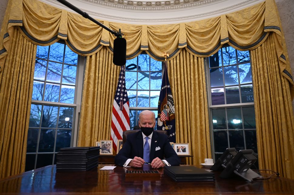 U.S. President Joe Biden holds a pen as he prepares to sign a series of orders in the Oval Office of the White House in Washington, D.C., after being sworn in at the US Capitol on Jan. 20, 2021.