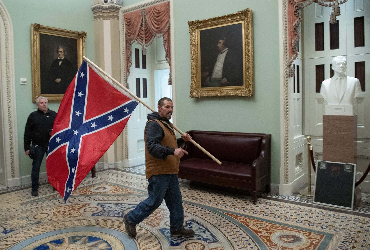 A Trump supporter carried a Confederate battle flag after breaking into the Capitol on Jan. 6.