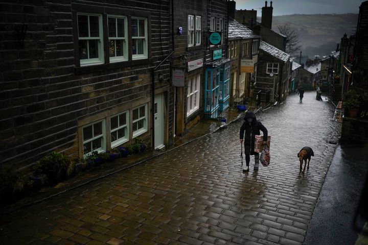 The rain of Storm Christoph and the national pandemic lockdown creates a near deserted Main Street near the Bronte Museum in Haworth