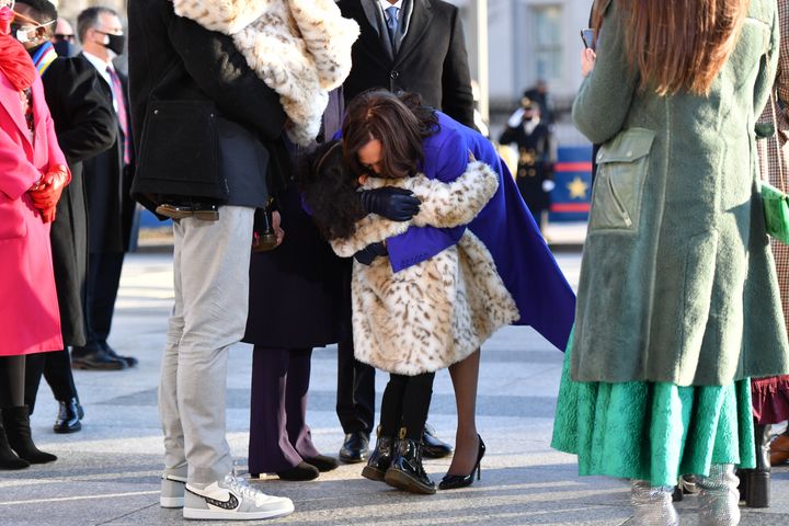 Harris hugs her great-niece Amara before walking the parade route with her family. Ajagu's shoes are visible on the left.