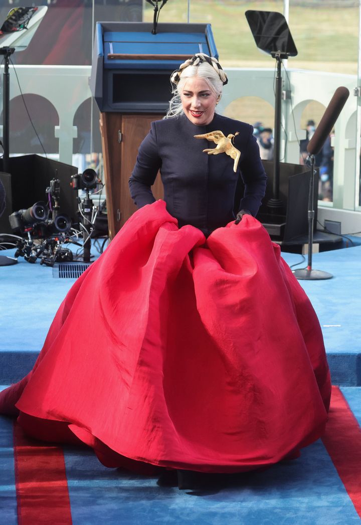 Lady Gaga picks up her skirt after singing the national anthem during the inauguration.