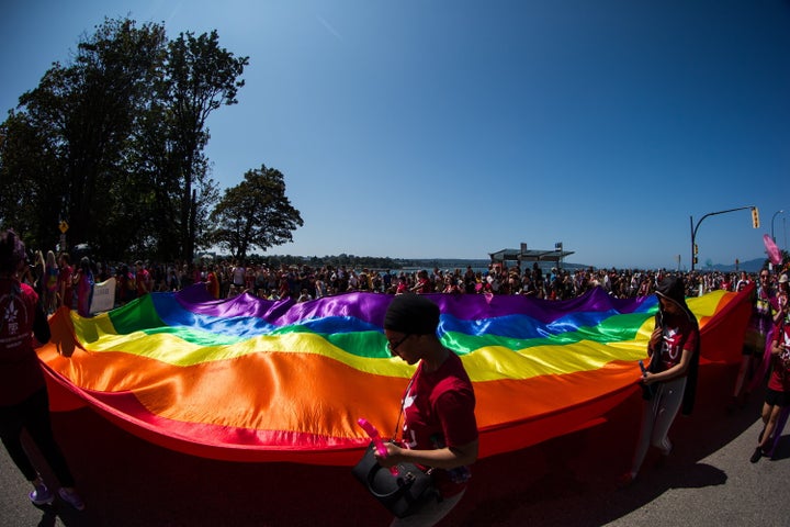 People carry a large rainbow flag during the Vancouver Pride Parade, on Aug. 4, 2019.