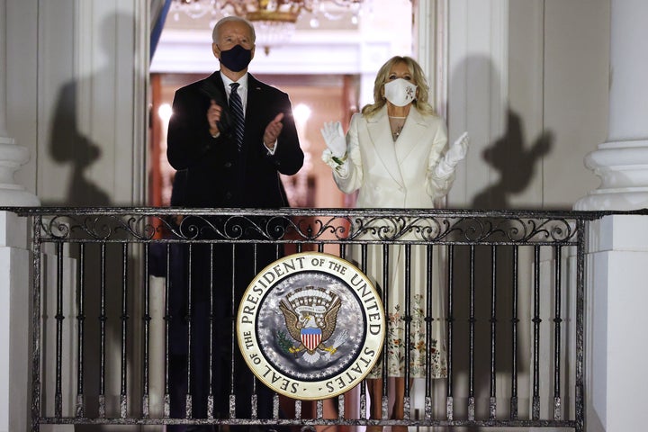 The couple watches the night's fireworks show on the National Mall from the Truman Balcony at the White House.