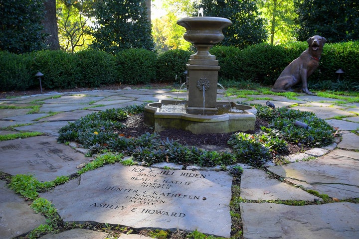 The Bidens added the Family Heritage Garden of the Vice President, where all occupants and their family members, including pets, are memorialized on the stone pavers around a fountain. In this photo from Oct. 28, 2016, a fiberglass replica of a bronze dog by artist Charles Parks is on loan and wears the collar of the Biden's dog, Champ.